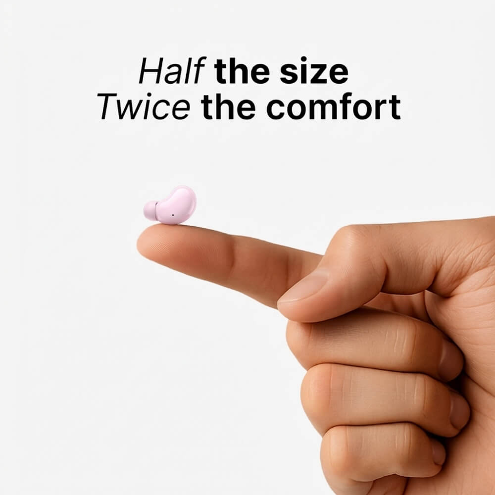 Digital product image of a tiny pale pink bean-shaped wireless earbud resting on a human index fingertip against a minimalist white background, featuring the text Half the size Twice the comfort